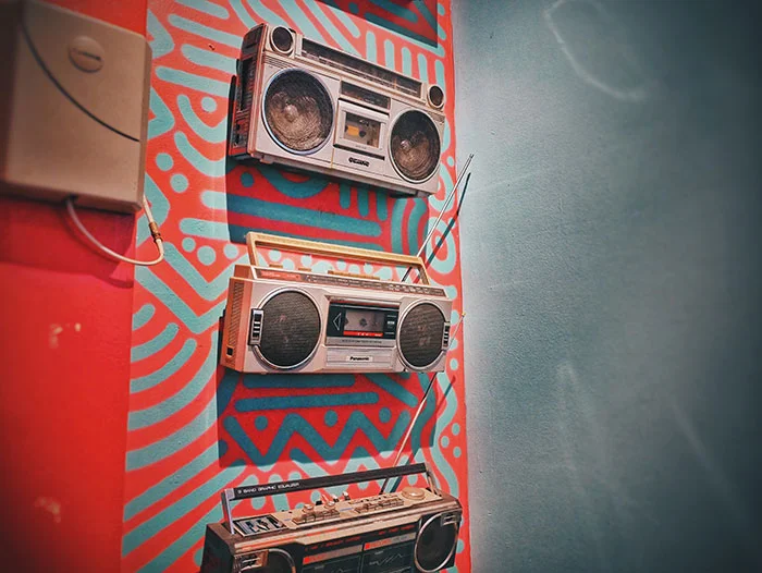 Vintage boomboxes on colorful background
